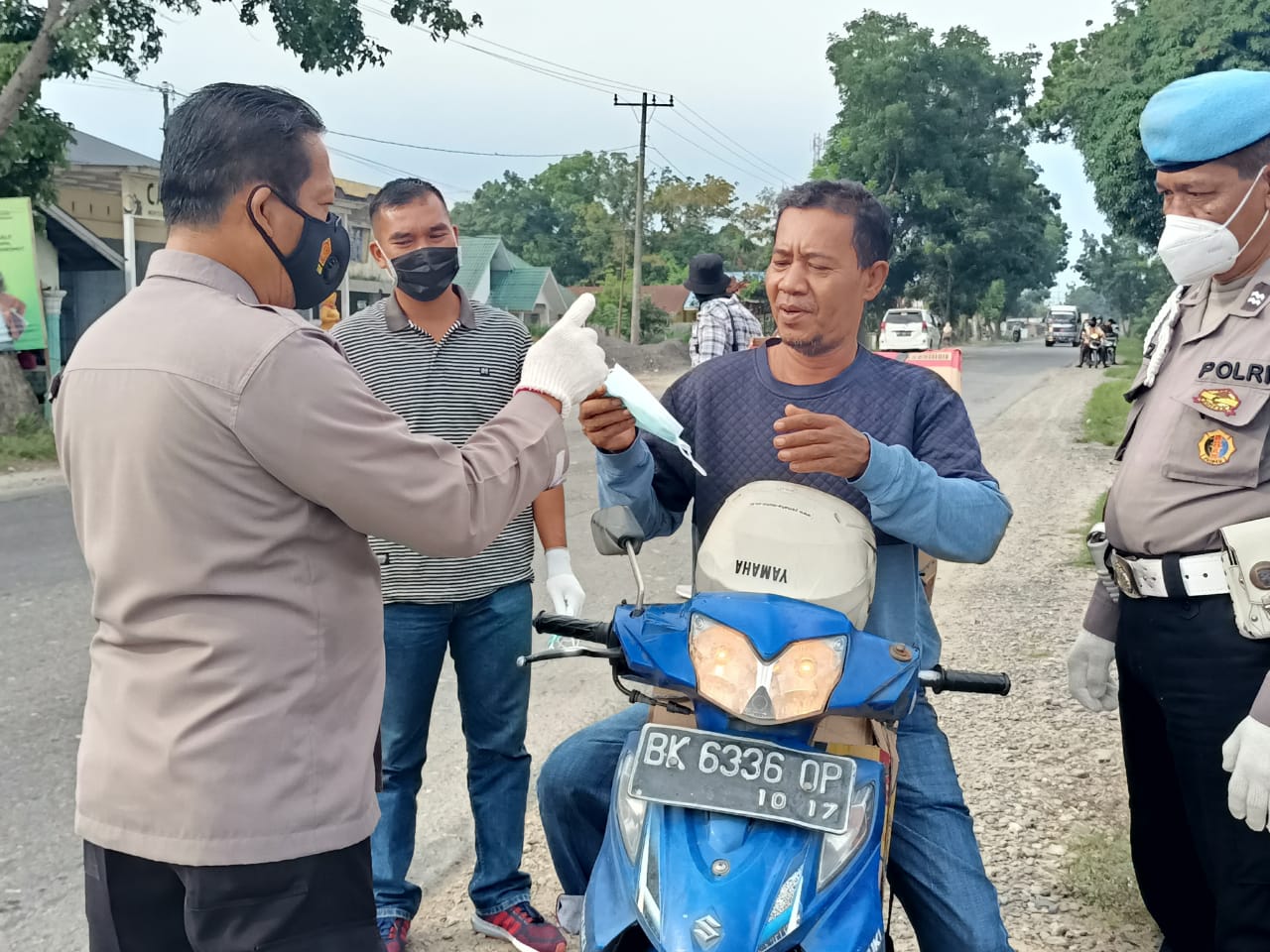 Polsek Hinai Melakukan Operasi Yustisi dan Membagikan Masker